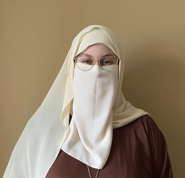 Image of Zaina with mustard wall background